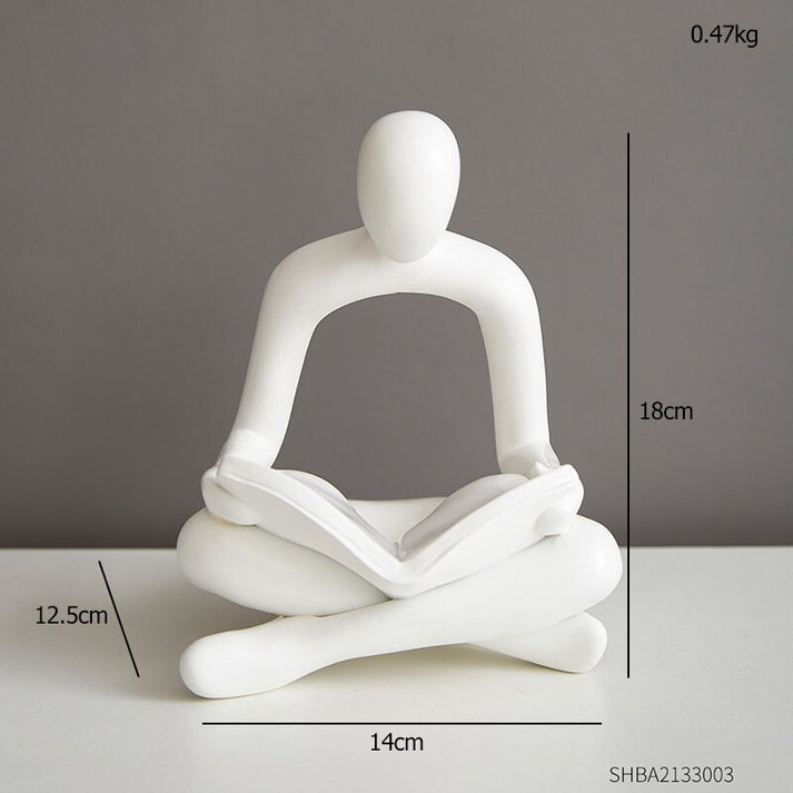 Set of 2 black and white reading statues.